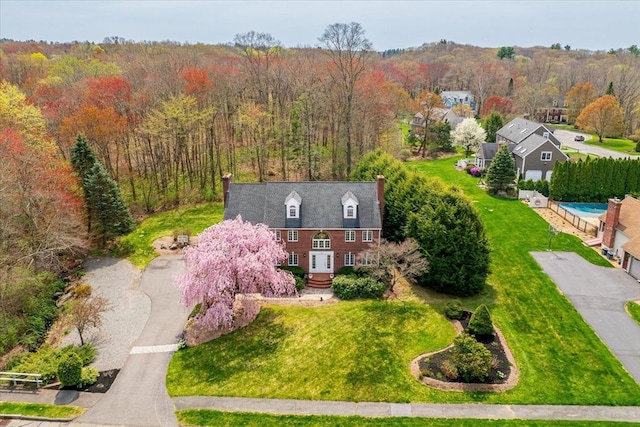 birds eye view of property featuring a view of trees