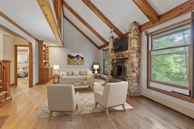 living room with high vaulted ceiling, a stone fireplace, light wood-style floors, stairs, and beamed ceiling