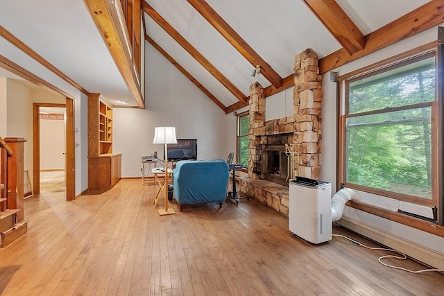 home office featuring light wood-type flooring, plenty of natural light, and a fireplace