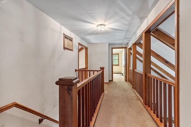 hallway with light carpet and an upstairs landing