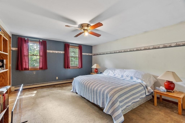 carpeted bedroom featuring a baseboard heating unit, ceiling fan, and baseboards