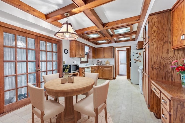 dining area with light floors, french doors, beamed ceiling, and coffered ceiling