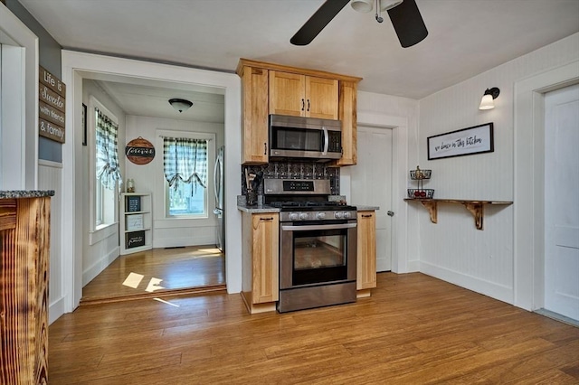 110 Middlefield Rd, Chester, MA 01011 - kitchen featuring appliances with stainless steel finishes, light wood finished floors, a ceiling fan, and a decorative wall