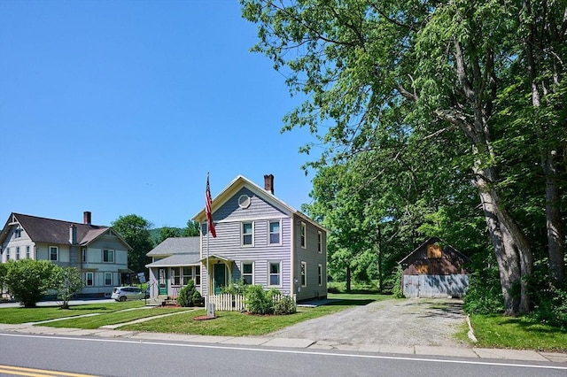 110 Middlefield Rd, Chester, MA 01011 - view of front of property featuring an outbuilding, a front yard, a chimney, dirt driveway, and a barn