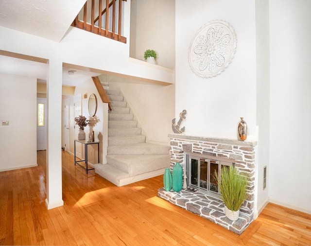 25 Church St Unit 2, Weymouth, MA 02189 - living area featuring wood finished floors, stairs, baseboards, and a glass covered fireplace