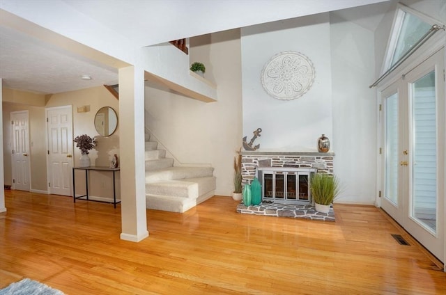 25 Church St Unit 2, Weymouth, MA 02189 - living room featuring wood finished floors, stairs, baseboards, healthy amount of natural light, and a towering ceiling