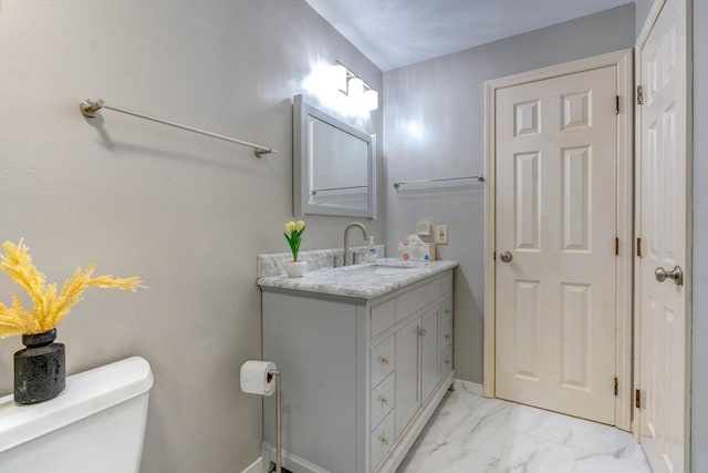 25 Church St Unit 2, Weymouth, MA 02189 - bathroom with marble finish flooring, vanity, toilet, and baseboards