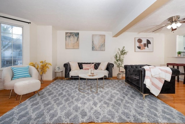 25 Church St Unit 2, Weymouth, MA 02189 - living room with wood finished floors, baseboards, beam ceiling, and a ceiling fan