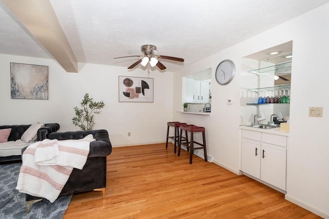 25 Church St Unit 2, Weymouth, MA 02189 - living room with light wood-style floors, ceiling fan, and baseboards