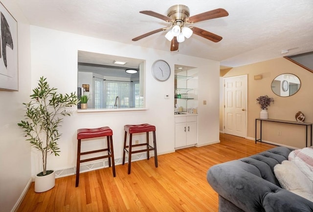 25 Church St Unit 2, Weymouth, MA 02189 - living area featuring light wood-style flooring, ceiling fan, and baseboards