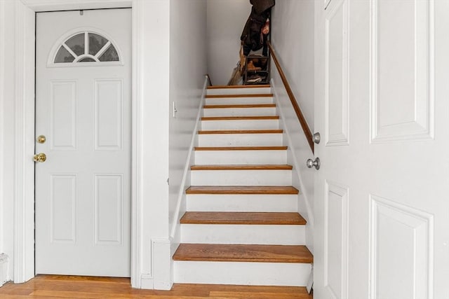 stairway with wood finished floors