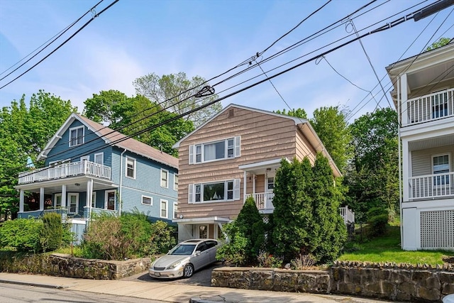 view of front of home featuring a balcony