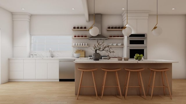 kitchen with decorative light fixtures, a center island, white cabinetry, and stainless steel appliances