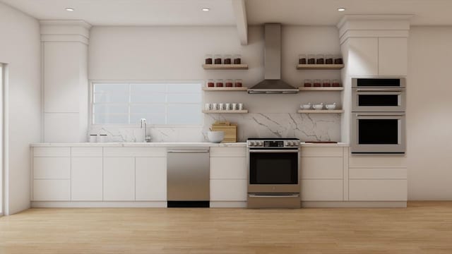 kitchen featuring white cabinets, decorative backsplash, exhaust hood, and appliances with stainless steel finishes