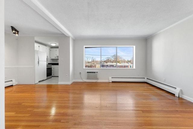 unfurnished living room with light hardwood / wood-style flooring, a baseboard radiator, and a wall mounted AC