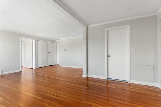 empty room featuring hardwood / wood-style floors and ornamental molding