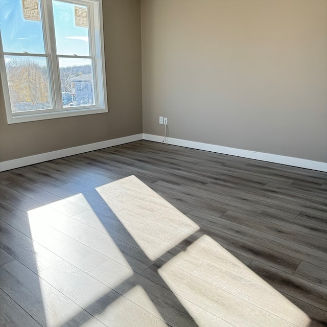 spare room with hardwood / wood-style floors