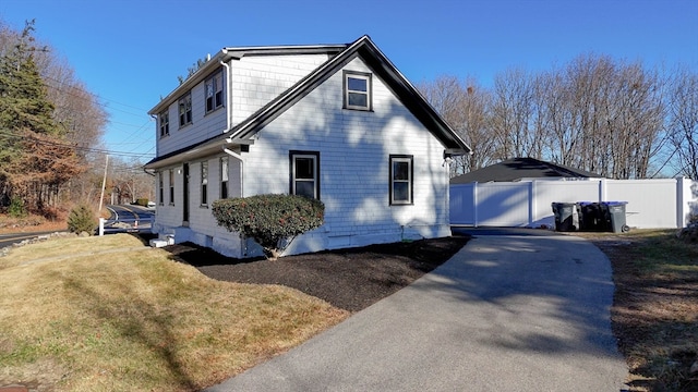 view of side of home with a lawn