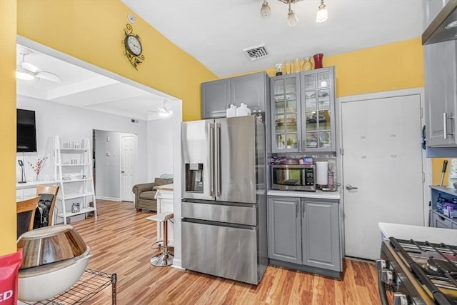 kitchen featuring light hardwood / wood-style flooring, gray cabinets, and appliances with stainless steel finishes