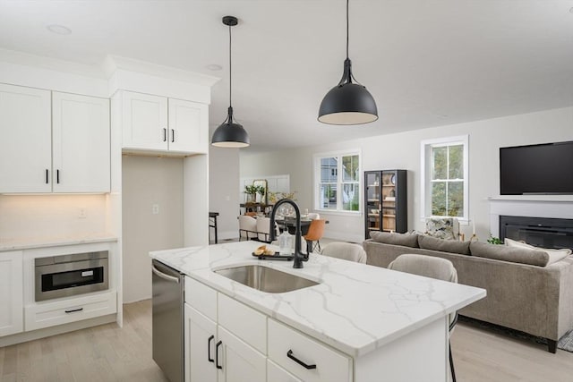 20 Howland Trl Unit 10, Hanson, MA 02341 - kitchen featuring appliances with stainless steel finishes, open floor plan, light wood-type flooring, and pendant lighting