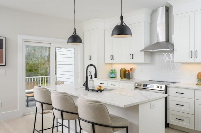 20 Howland Trl Unit 10, Hanson, MA 02341 - kitchen featuring wall chimney range hood, stainless steel electric stove, tasteful backsplash, light stone countertops, and a breakfast bar
