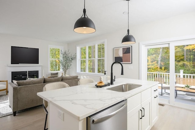 20 Howland Trl Unit 10, Hanson, MA 02341 - kitchen with stainless steel dishwasher, light wood-style floors, light stone countertops, decorative light fixtures, and white cabinetry