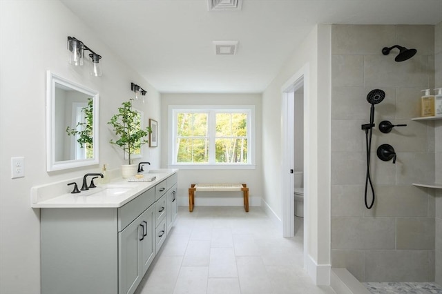 20 Howland Trl Unit 10, Hanson, MA 02341 - bathroom with double vanity, a tile shower, and tile patterned flooring