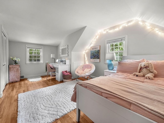 125 Grove St, Norwell, MA 02061 - bedroom featuring vaulted ceiling, multiple windows, and wood finished floors