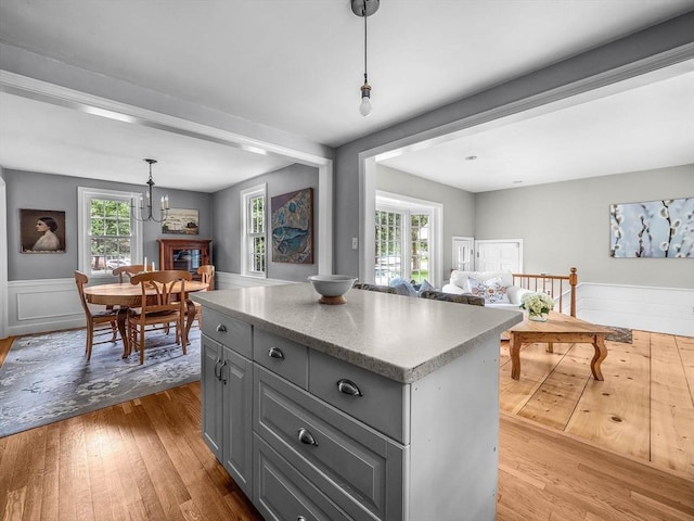 125 Grove St, Norwell, MA 02061 - kitchen with gray cabinetry, wood finished floors, a kitchen island, and open floor plan