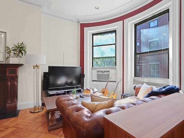 living room with cooling unit, light parquet flooring, and ornamental molding