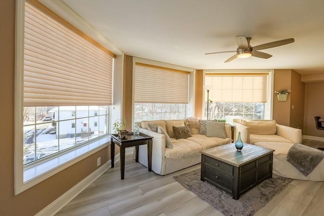 living room with light hardwood / wood-style flooring and ceiling fan