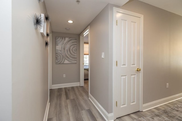 corridor with light hardwood / wood-style flooring