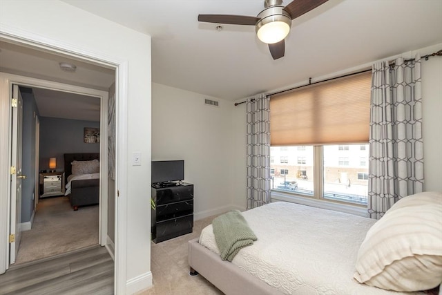 bedroom with ceiling fan and light wood-type flooring