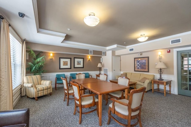 dining area featuring crown molding and carpet floors