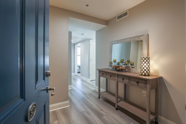 hall with light hardwood / wood-style floors