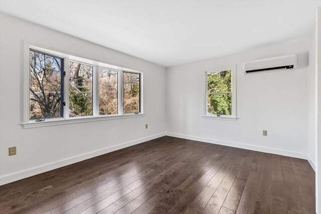 506 Woods Hole Rd, Falmouth, MA 02543 - empty room featuring a wall mounted air conditioner, dark wood-style floors, and baseboards
