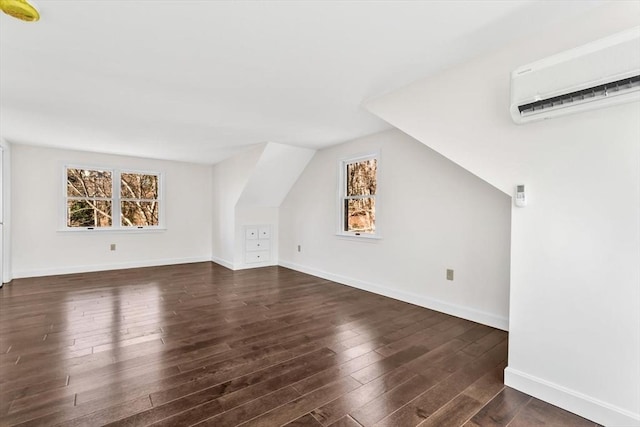 506 Woods Hole Rd, Falmouth, MA 02543 - additional living space featuring a wall mounted AC, dark wood-type flooring, vaulted ceiling, and baseboards