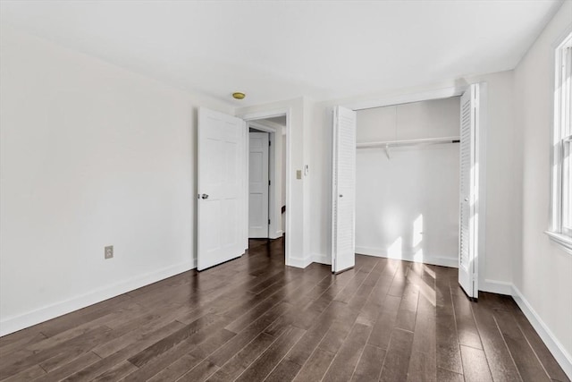 506 Woods Hole Rd, Falmouth, MA 02543 - unfurnished bedroom featuring dark wood finished floors, baseboards, and a closet