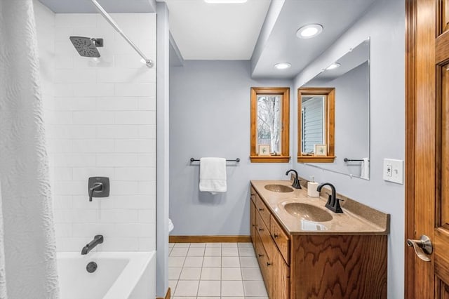 full bath with tile patterned flooring, a sink, baseboards, double vanity, and shower / bath combo with shower curtain