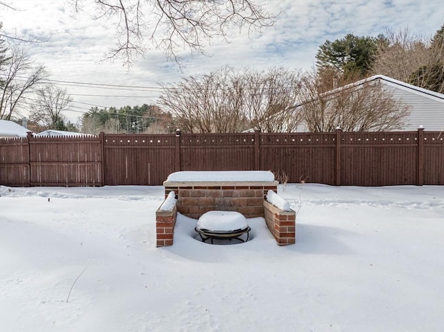 yard covered in snow featuring a fenced backyard