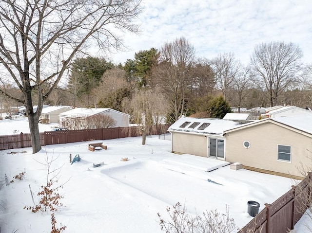 yard covered in snow with a fenced backyard