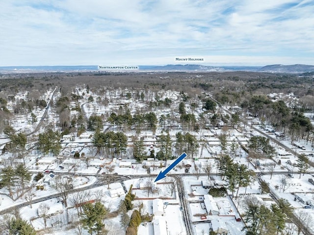 snowy aerial view with a mountain view