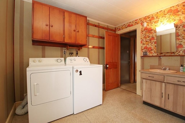 washroom featuring a sink, light floors, wallpapered walls, and independent washer and dryer