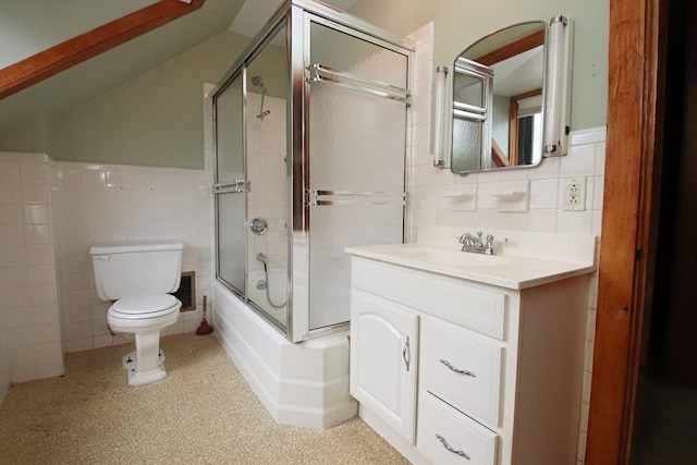 bathroom featuring tile walls, bath / shower combo with glass door, vanity, and toilet