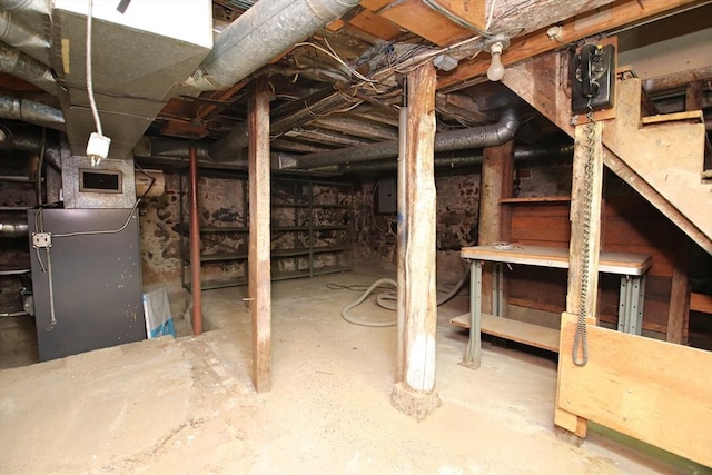 unfinished below grade area with visible vents, heating unit, and electric panel