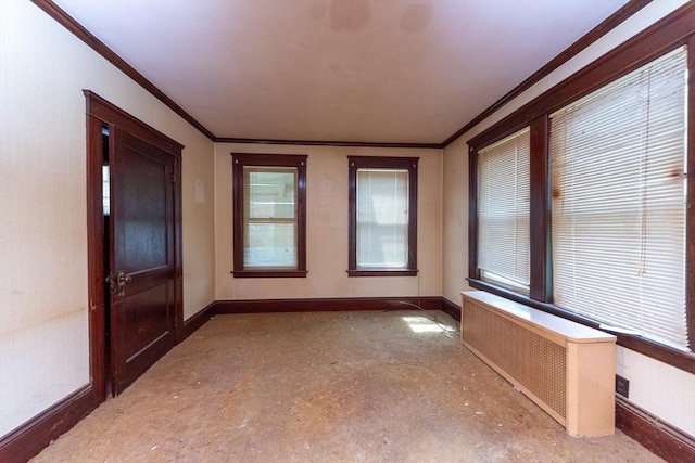 empty room with radiator heating unit, crown molding, and baseboards