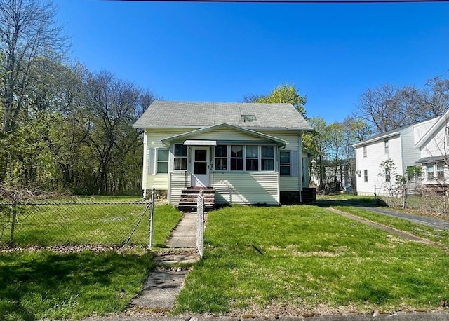 view of front of home featuring roof with shingles, a sunroom, and entry steps
