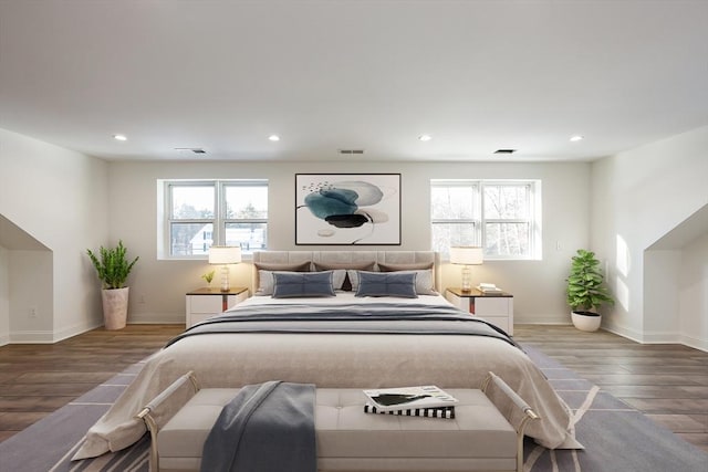 bedroom featuring hardwood / wood-style floors and multiple windows