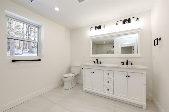 bathroom featuring tile patterned flooring, vanity, toilet, and a shower