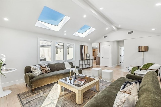 living room featuring vaulted ceiling with beams and light hardwood / wood-style floors